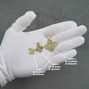 Three different sized gold nugget clover pendants shown on a white-gloved hand with measurement guides.