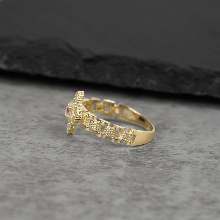 10k Clover Rollie Gold ring with a pink Cubic Zirconia side view on a gray surface