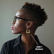 Side profile of a model wearing the 38.0mm Size 1 gold bamboo square hoop.