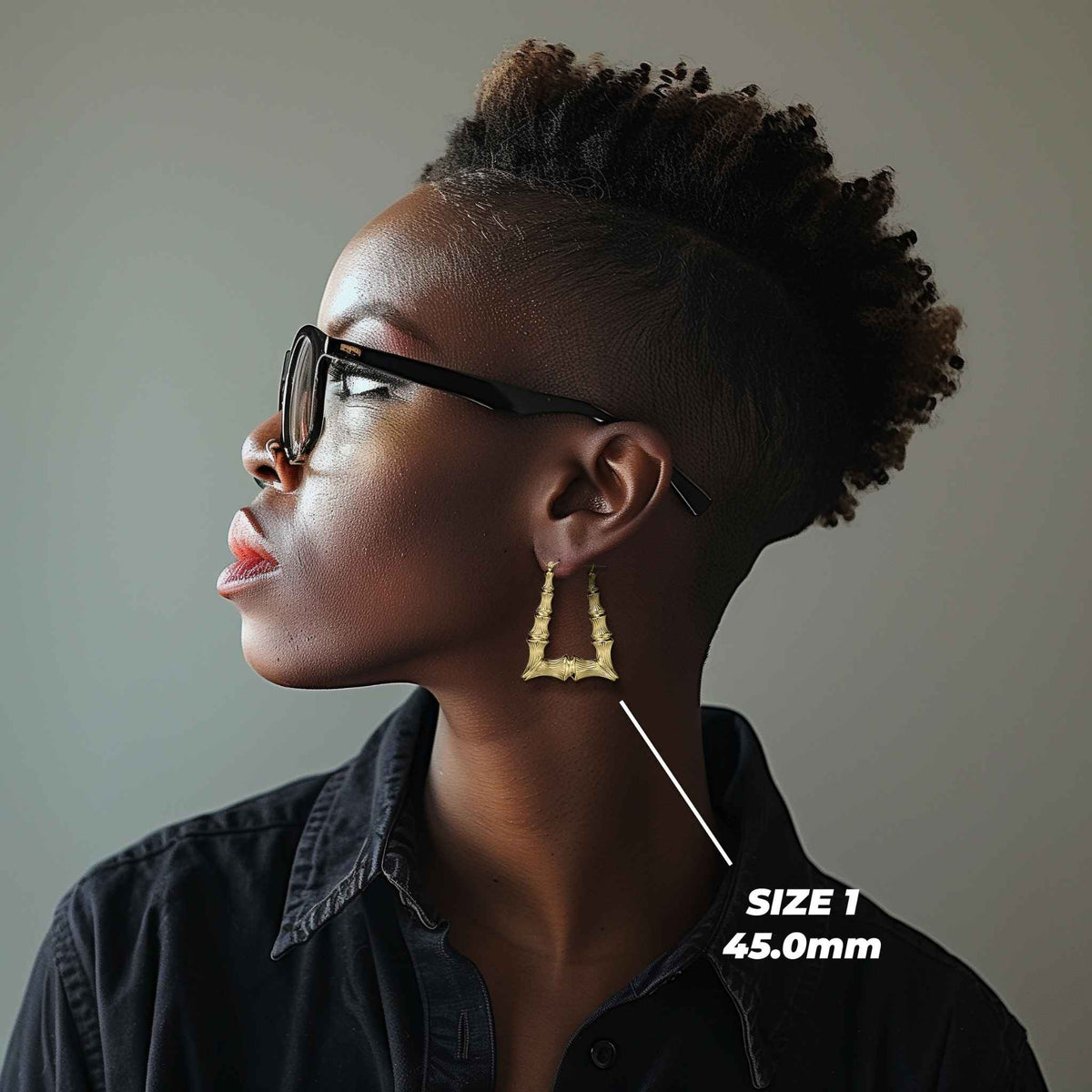 Model wearing a 45.0mm Size 1 gold bamboo square hoop earring for size reference.