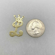 Gold crown-topped cursive letter "L" earring next to a quarter for size reference.