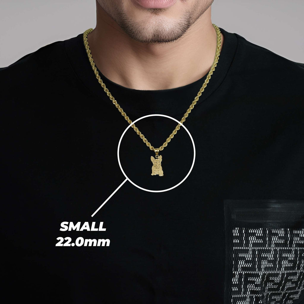 A man wearing a small gold French Bulldog pendant labeled SMALL 22.0mm.