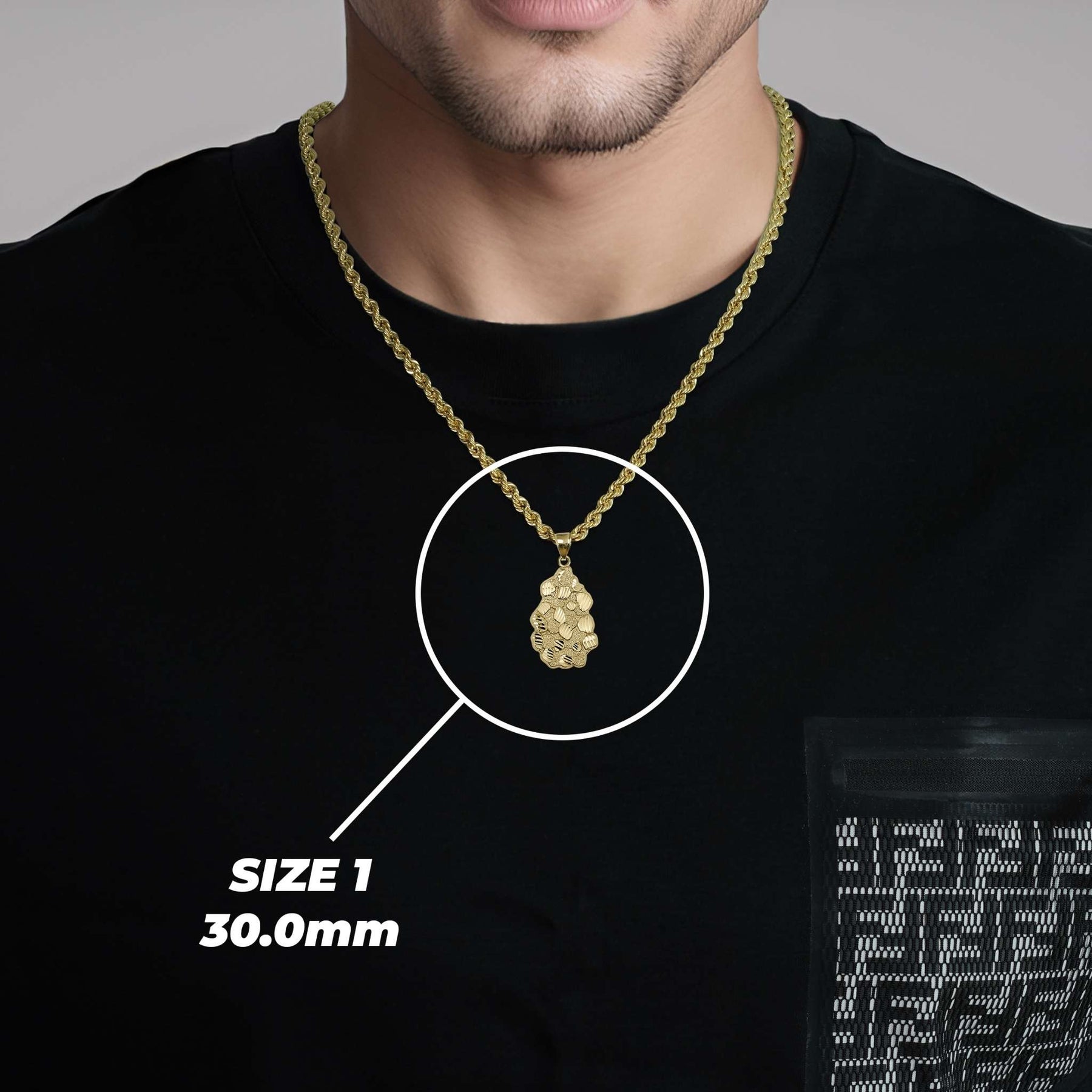 A man wearing a black shirt and a gold chain necklace showcasing the size 1 (30.0mm) vintage nugget pendant.