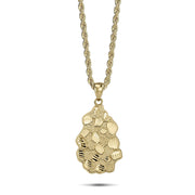 A 10k yellow gold vintage nugget pendant featuring a diamond-cut textured finish on a rope chain.