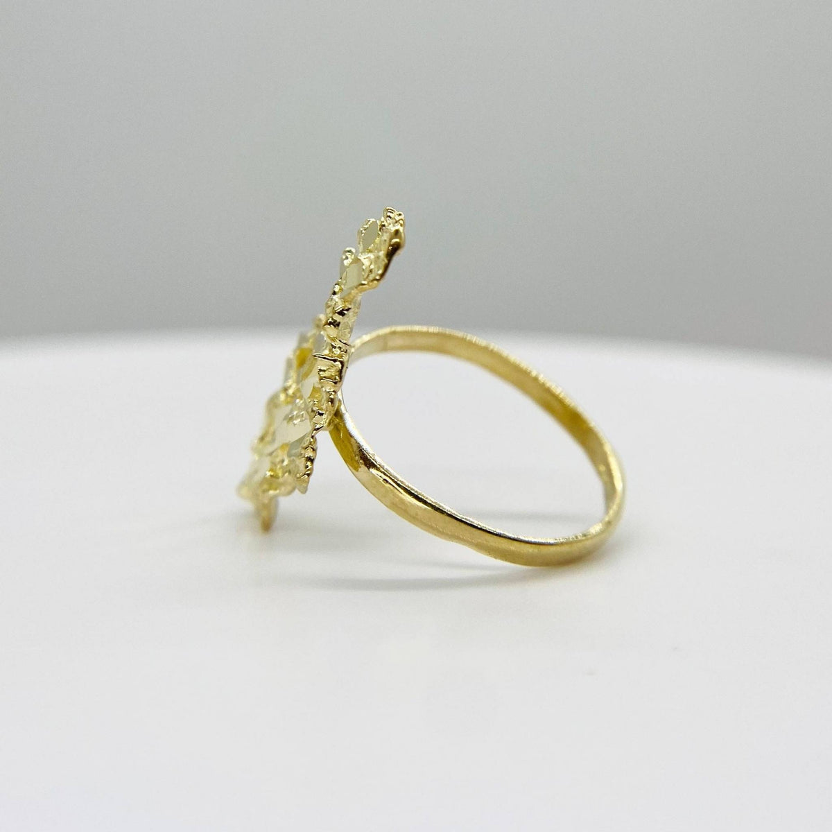 10k Gold Vintage Nugget ring with intricate design side view on a light gray background