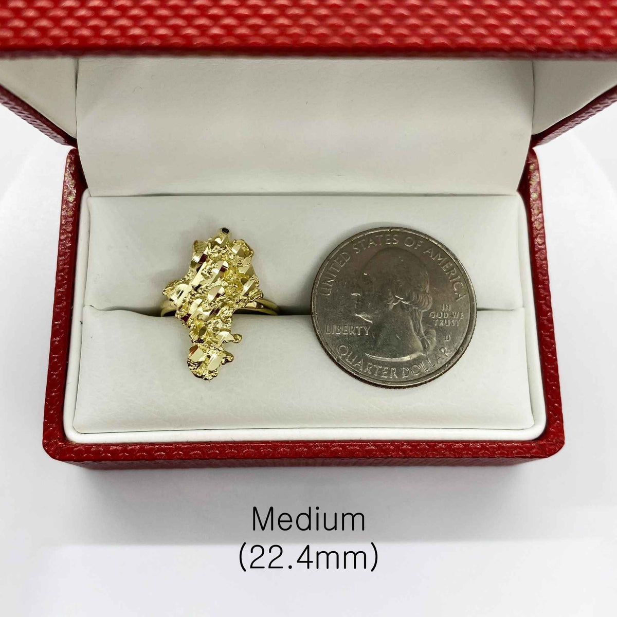 10k Gold Vintage Nugget ring in a red open box with a silver coin for scale on a white background