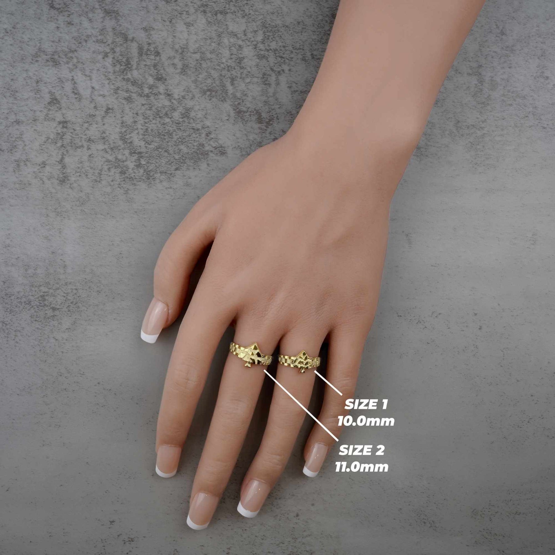 Hand wearing two 10k gold nugget ring with spade design with size label