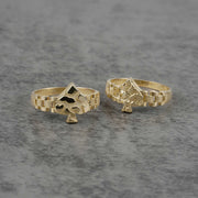 front view of two 10K gold vintage spade nugget rings on a gray surface