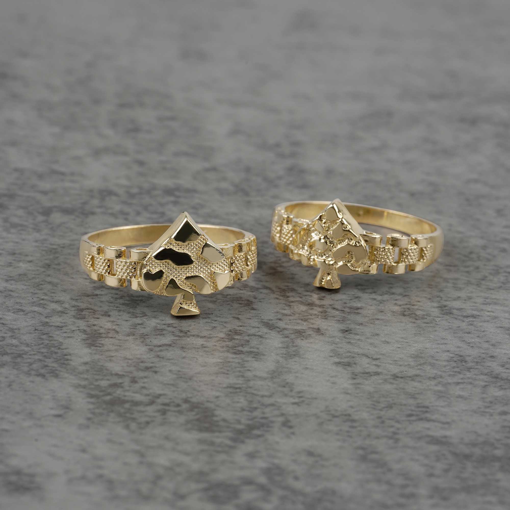front view of two 10K gold vintage spade nugget rings on a gray surface