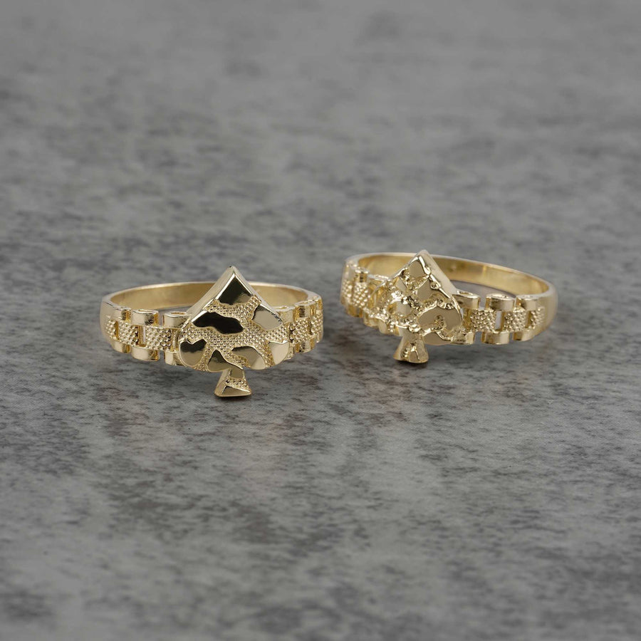 front view of two 10K gold vintage spade nugget rings on a gray surface