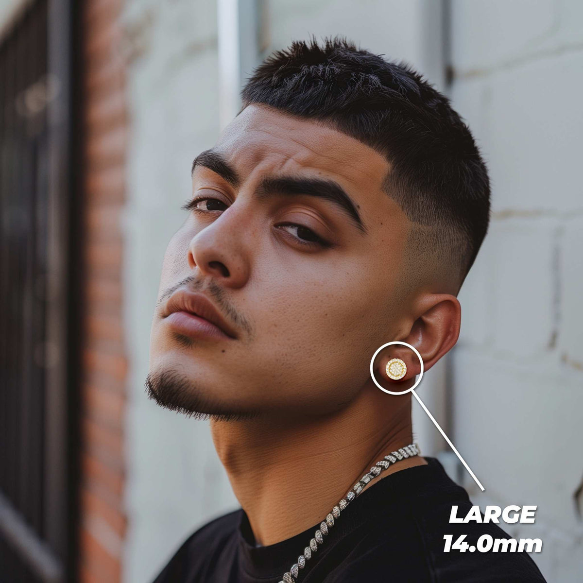 Man wearing a large 14.0mm gold Vinx round cubic zirconia stud earring on his ear.