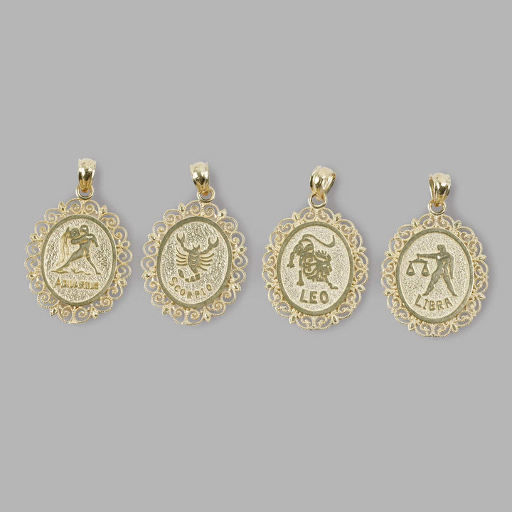 Four solid 10k yellow gold zodiac pendants featuring the Aquarius, Scorpio, Leo, and Libra designs against a gray backdrop.