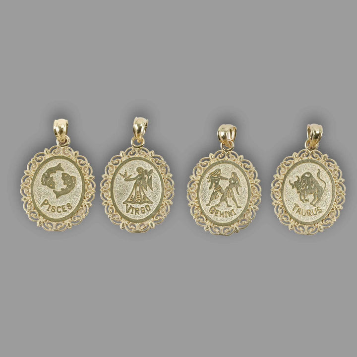 Four solid 10k yellow gold zodiac pendants featuring Pisces, Virgo, Gemini, and Taurus against a gray backdrop.
