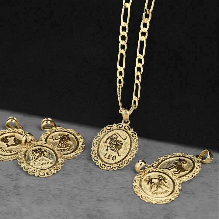 10k solid yellow gold zodiac charms including Leo, Pisces, Aquarius, and Gemini on a dark display.