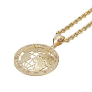 Round gold pendant displaying continental cutouts and engraved lettering hanging from a chain.