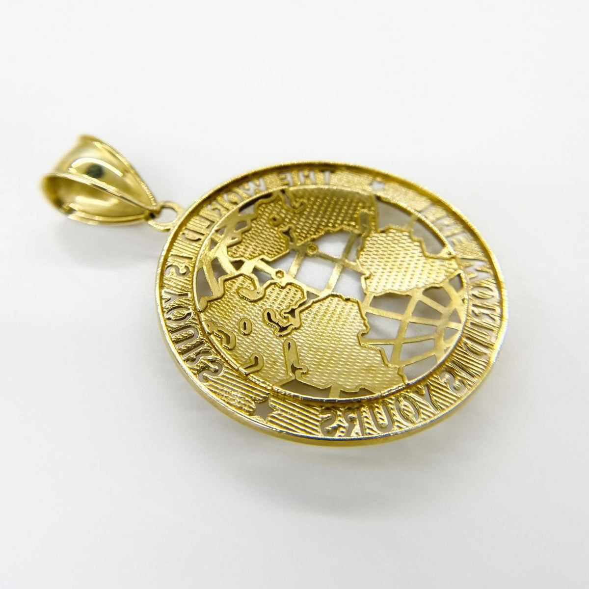 Backside perspective of gold 'The World Is Yours' globe pendant charm on a plain white background.