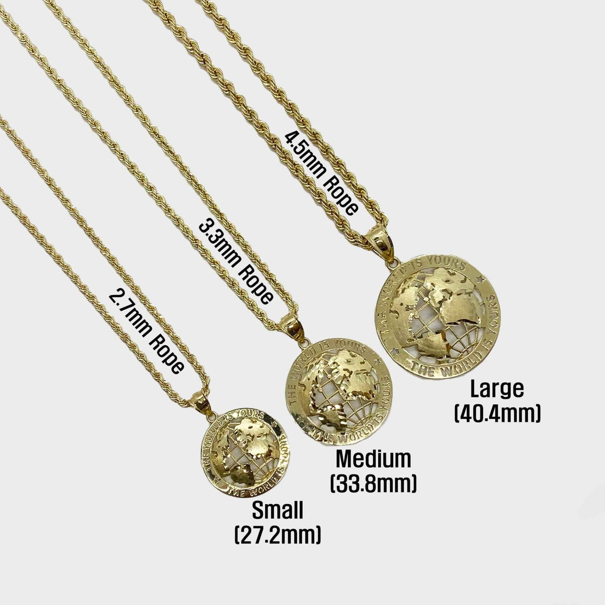 Three gold 'World Is Yours' globe pendants on rope chains with size labels.