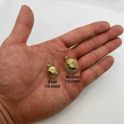Small and Medium 10k gold 3D world globe pendants held in an open hand