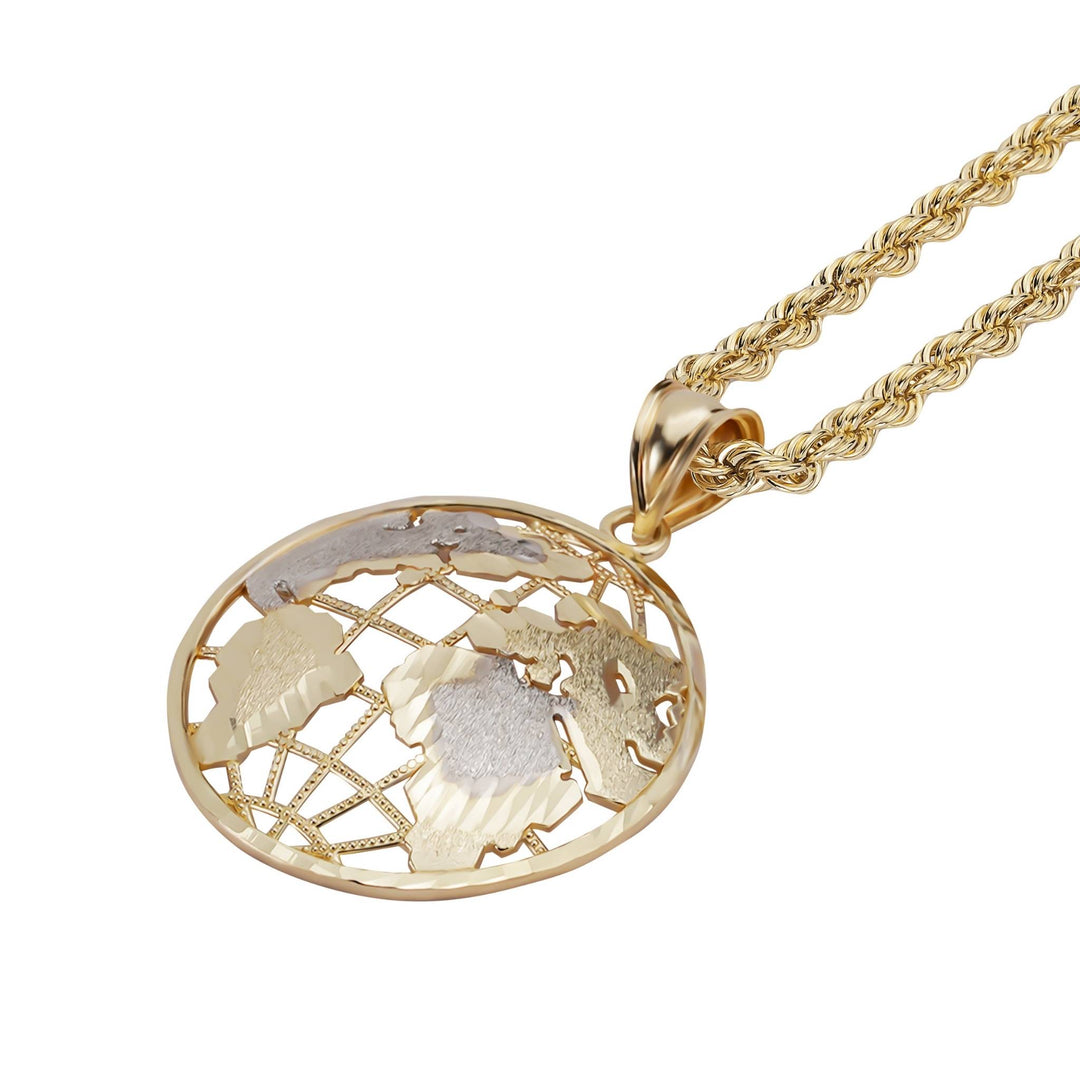 Hand holding a small two-tone gold globe pendant against a light background.