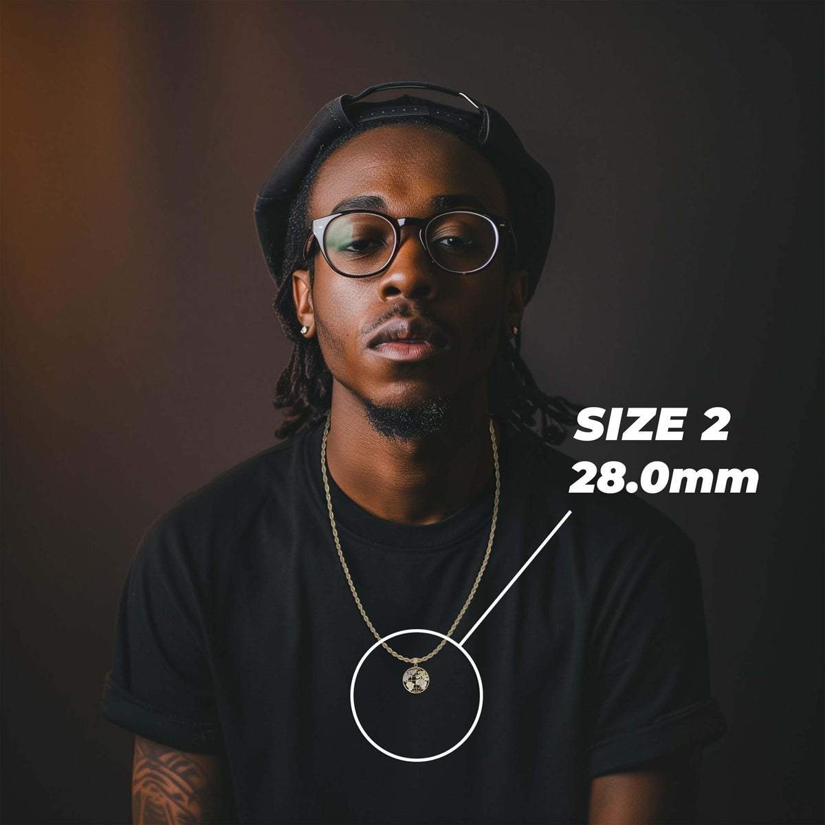 A man wearing round black-rimmed glasses and a black t-shirt, with a gold chain necklace featuring a small circular pendant. White text on the right reads 'SIZE 2'.