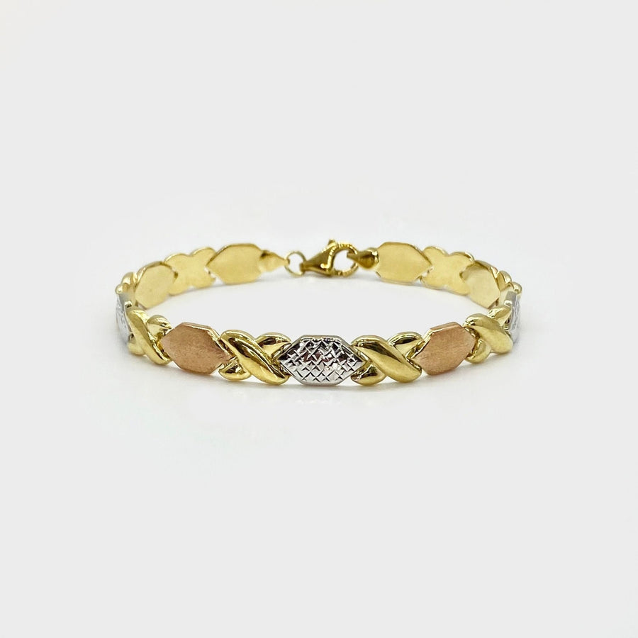 10k tri-color gold XO heart and kiss Stampato bracelet on white background.