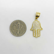 Size comparison of a 10k gold paved CZ Hamsa hand pendant charm displayed next to a US dime.