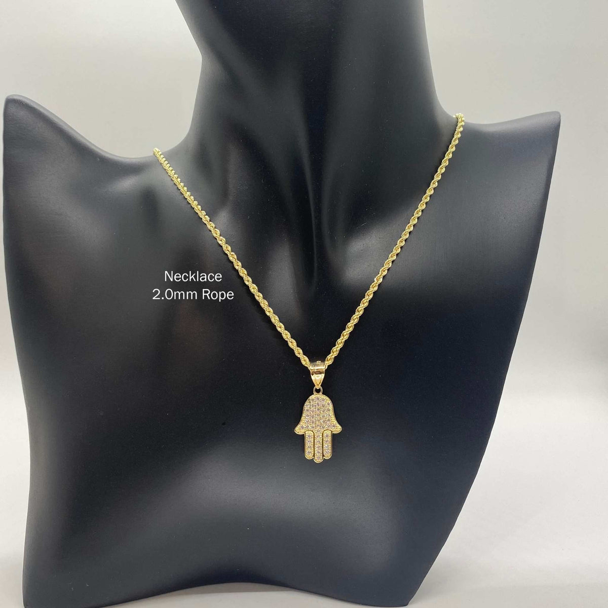 10k gold paved CZ Hamsa hand pendant necklace on a 2.0mm rope chain displayed on a black mannequin bust.