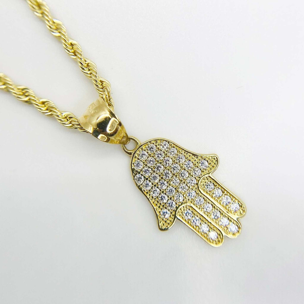 Front close-up of a 10k gold paved CZ Hamsa hand pendant charm on a rope chain.