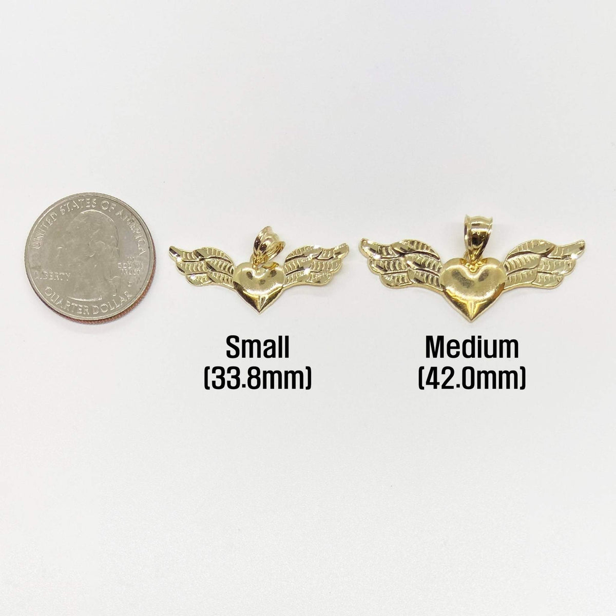 Size comparison of small 33.8mm and medium 42.0mm gold heart wing pendants next to a quarter.