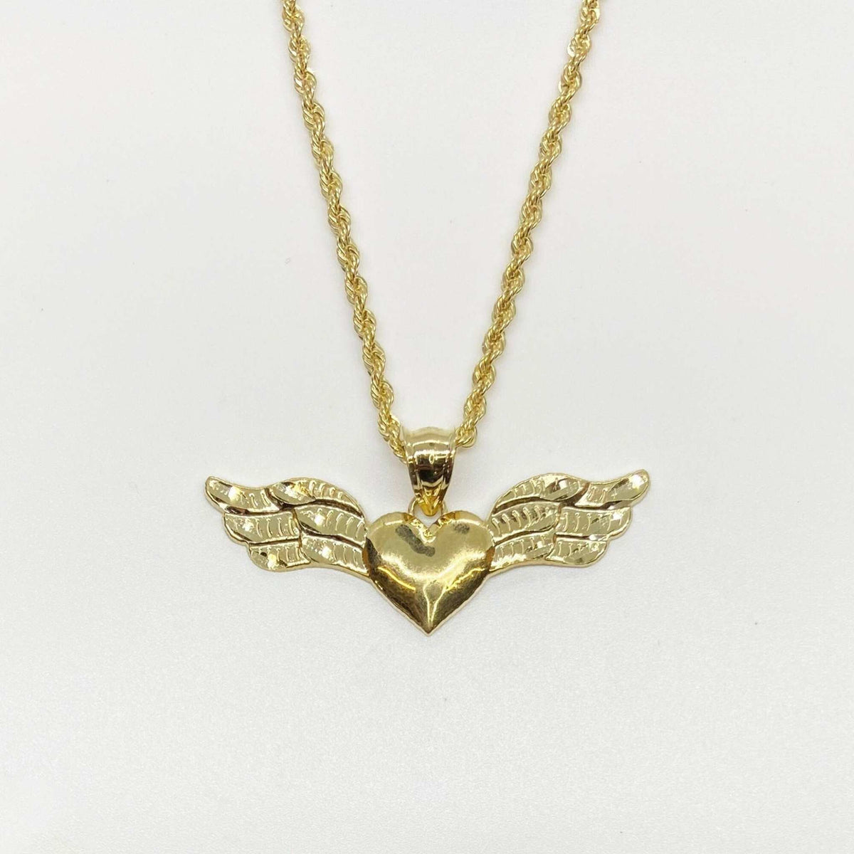 10k yellow gold heart pendant with outstretched angel wings on a gold rope chain.