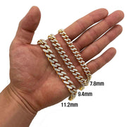 Hand displaying 10K gold iced-out Monaco Cuban link chain bracelets ranging from 7.8mm to 11.2mm.