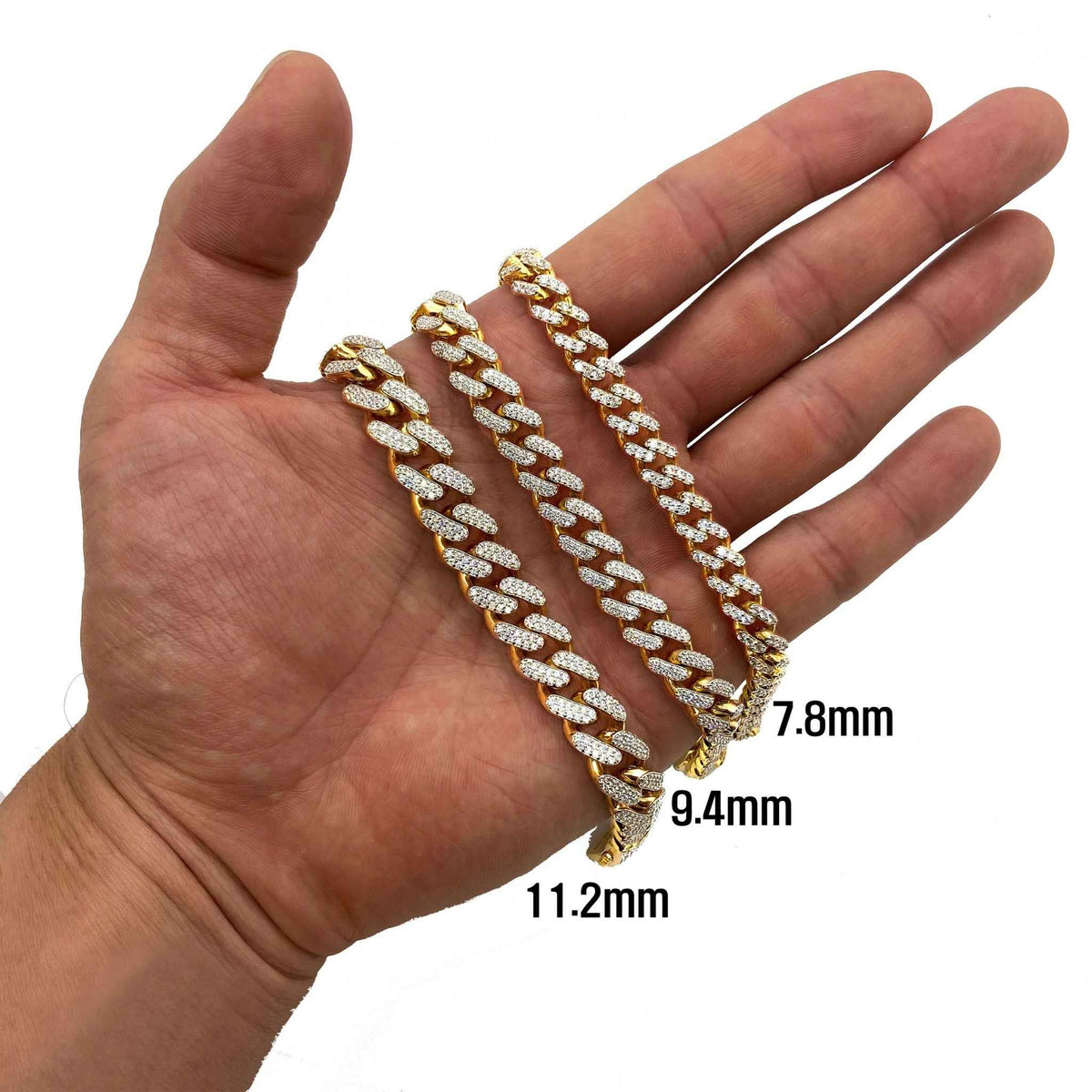 Hand displaying 10K gold iced-out Monaco Cuban link chain bracelets ranging from 7.8mm to 11.2mm.