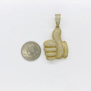 Size comparison of a 10k yellow gold iced-out thumbs up CZ pendant next to a quarter.