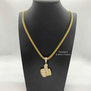 10k yellow gold iced-out thumbs up CZ pendant on a 4.8mm Franco chain displayed on a mannequin.