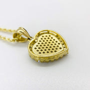 Back view of 10k gold heart pendant showing perforated metal backing and chain loop.