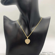 Medium 17.8mm 10k gold CZ heart pendant necklace on a black display bust.
