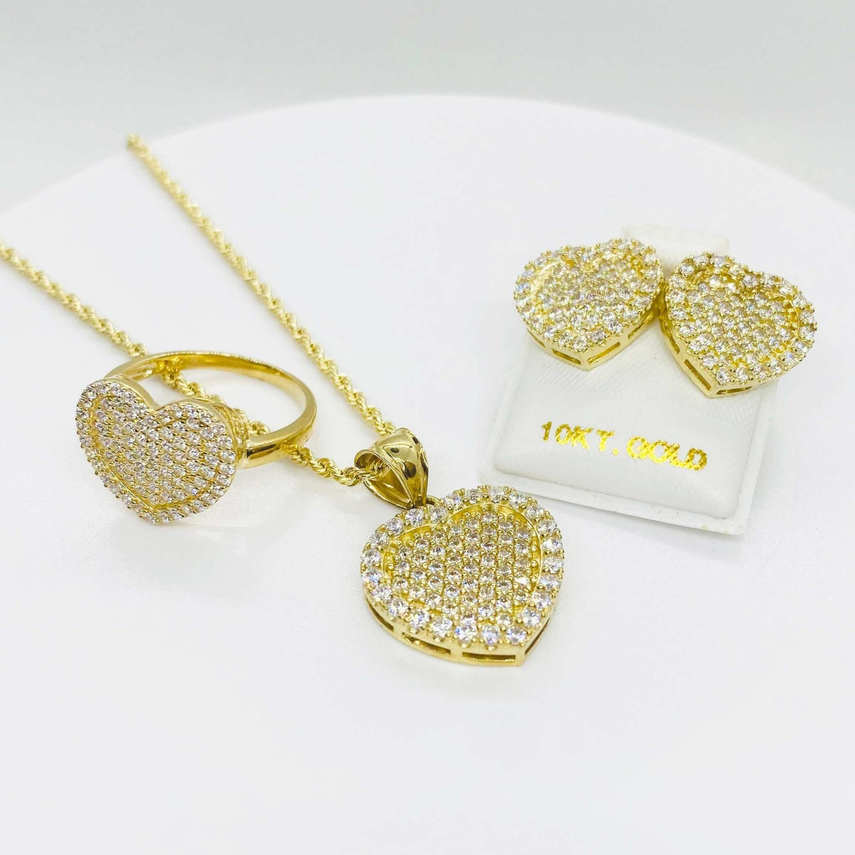 Matching 10k gold CZ heart pendant necklace, ring, and stud earrings jewelry set.