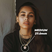 Woman wearing Medium 27.0mm gold pink CZ heart pendant necklace with layered chains