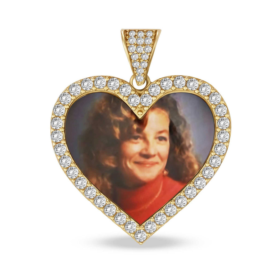 A heart-shaped gold pendant with a diamond halo and a photo of a smiling woman.