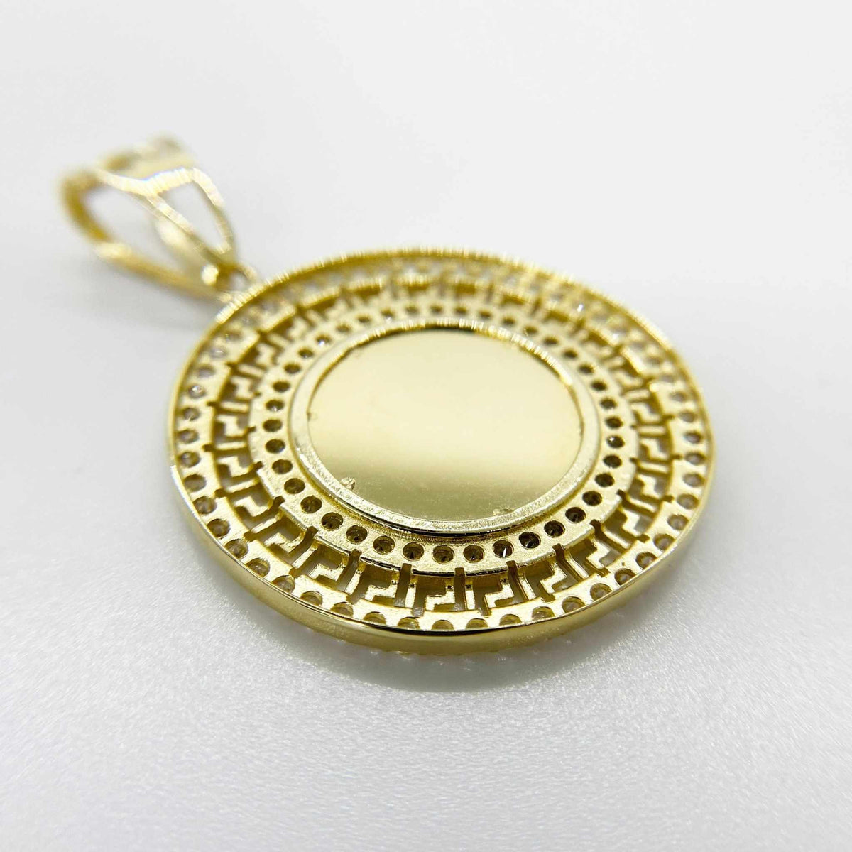 Plain textured back view of a round 10k gold Greek key memorial picture pendant.