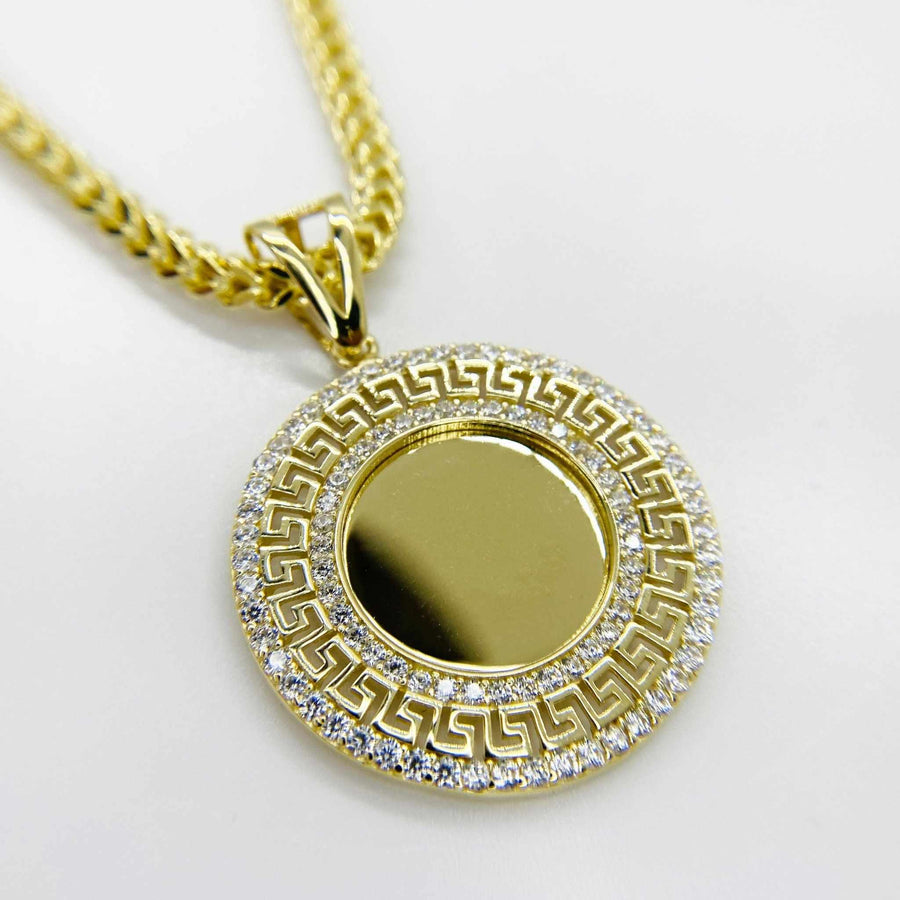 Round 10k gold memorial picture pendant with cubic zirconia stones and Greek key border.