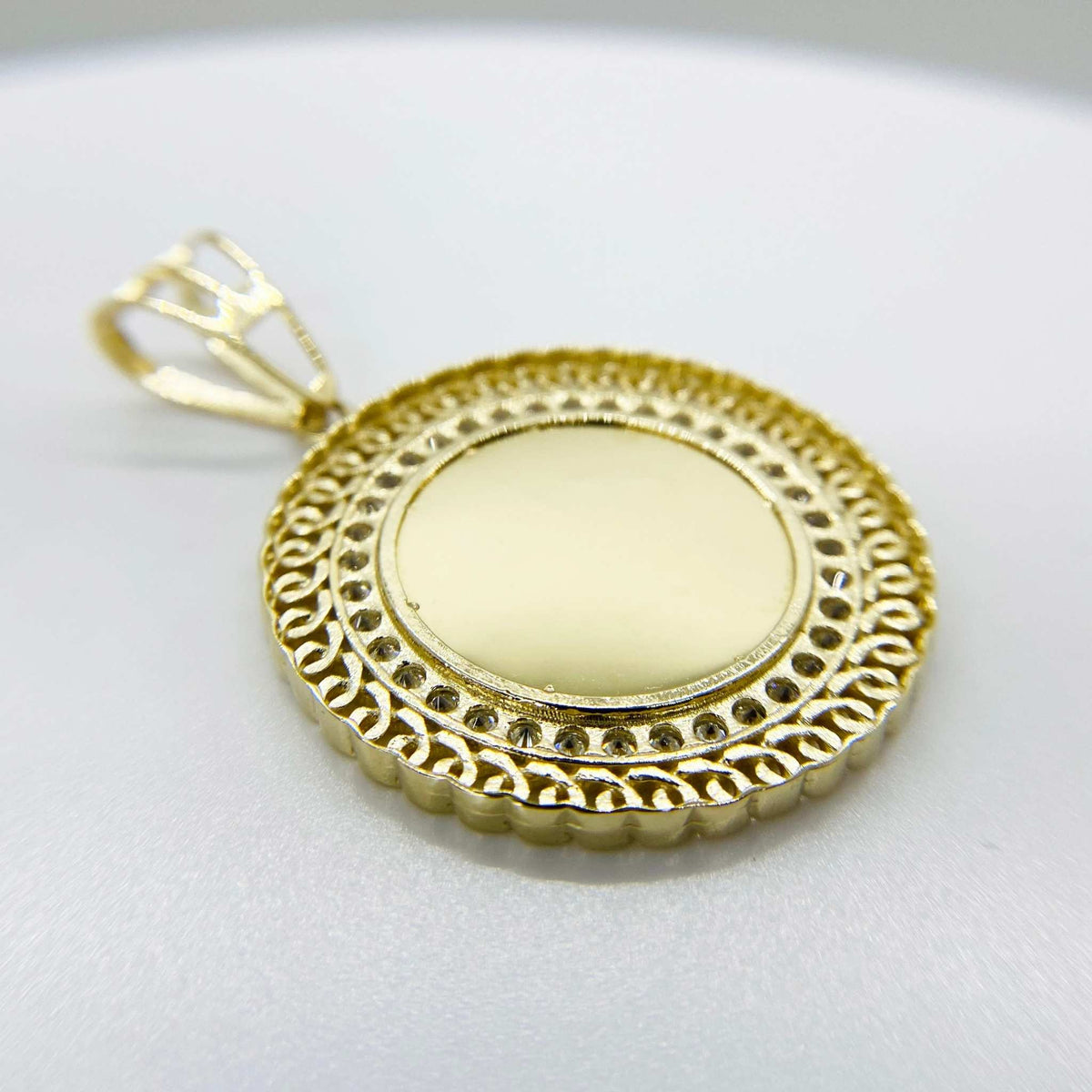 Angled view of a 10k gold round picture pendant with CZ halo.