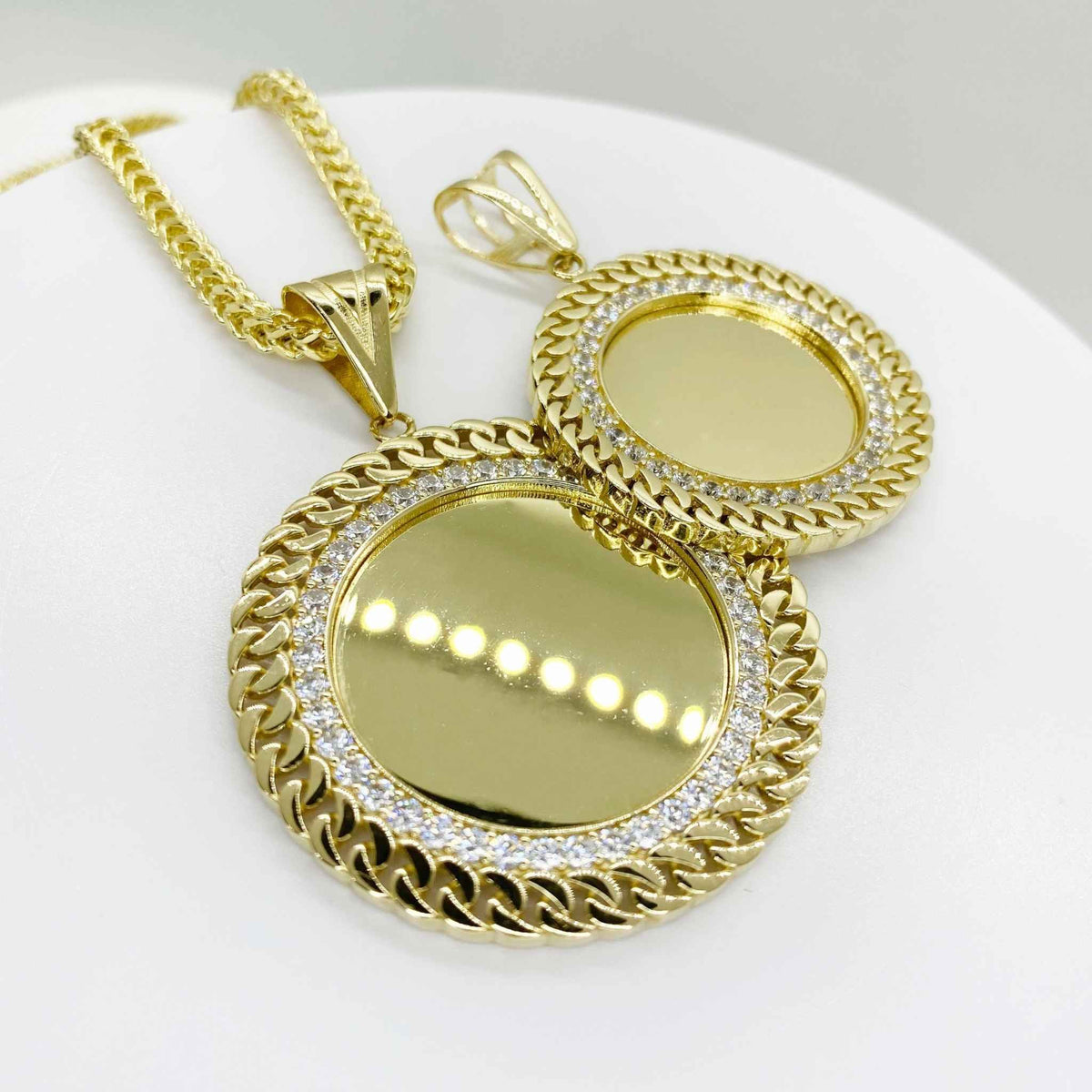 Two round 10k gold memorial picture pendants with Cuban-link borders and CZ halos.