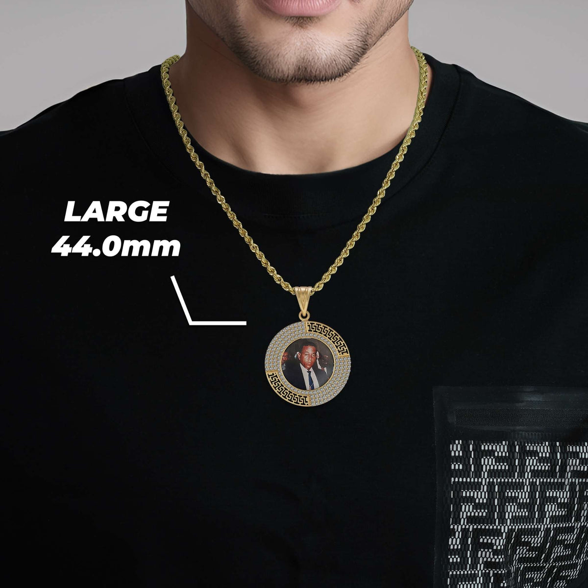 Man wearing a large 44.0mm round gold memorial portrait pendant on a chain.