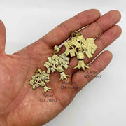 Three sizes of 10k yellow gold money bag tree pendants resting on an open palm.