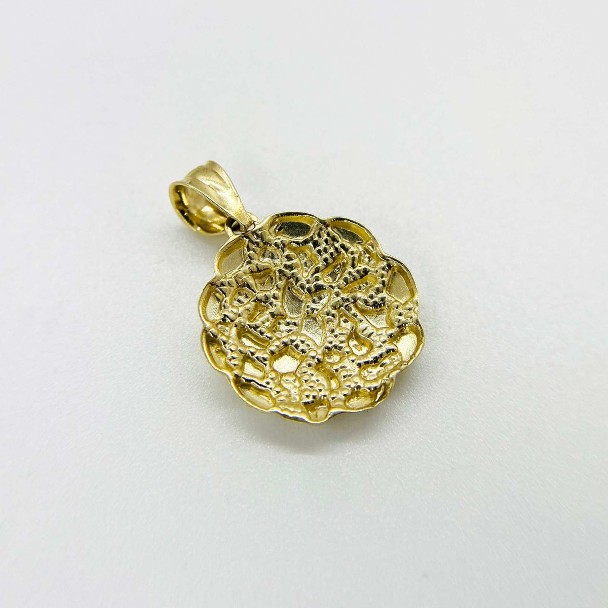 Back view of 10k gold round nugget pendant showing textured reverse side.