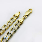 Close-up of a 10k gold pave curb link bracelet showing a lobster clasp and hallmark