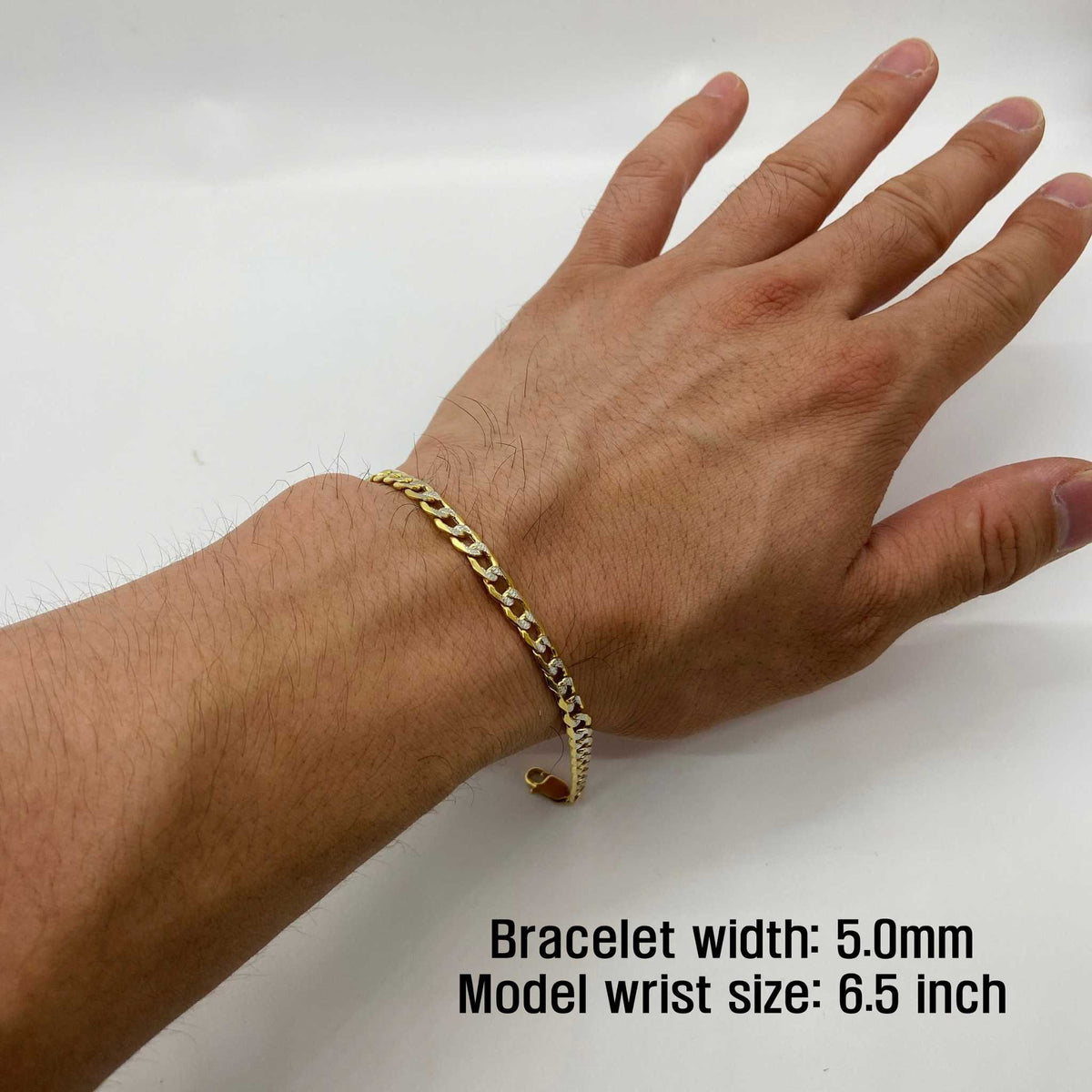 Close-up of a model wearing a 5.0mm 10k gold pave curb link bracelet on wrist