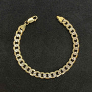 Polished 10k yellow gold Cuban link bracelet featuring diamond-cut pave details.