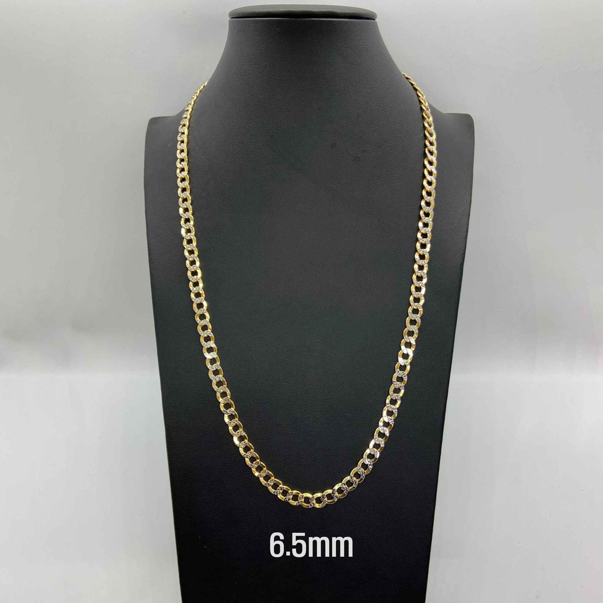 6.5mm 10k gold pave diamond cut Cuban curb chain displayed on black mannequin.